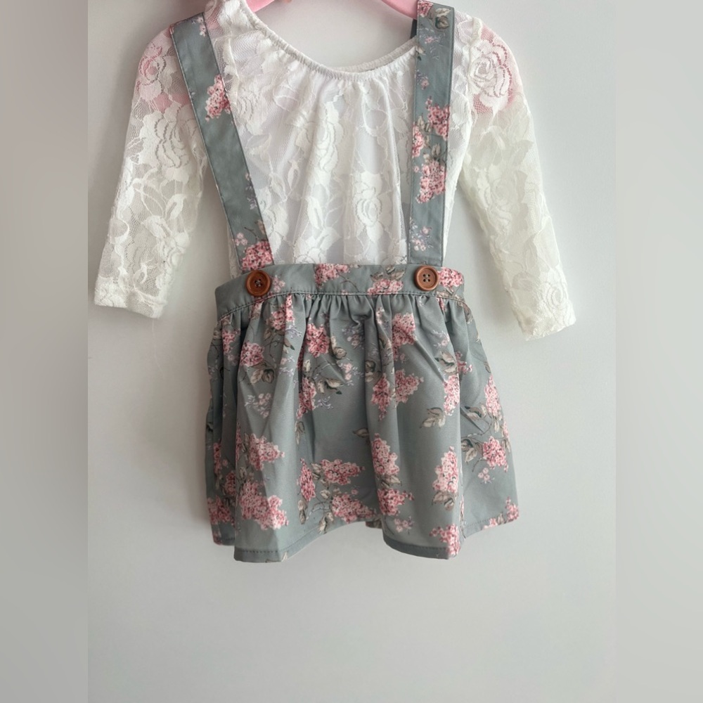 Skirt set 6-9 months . Includes onsie top , and floral skirt , with straps